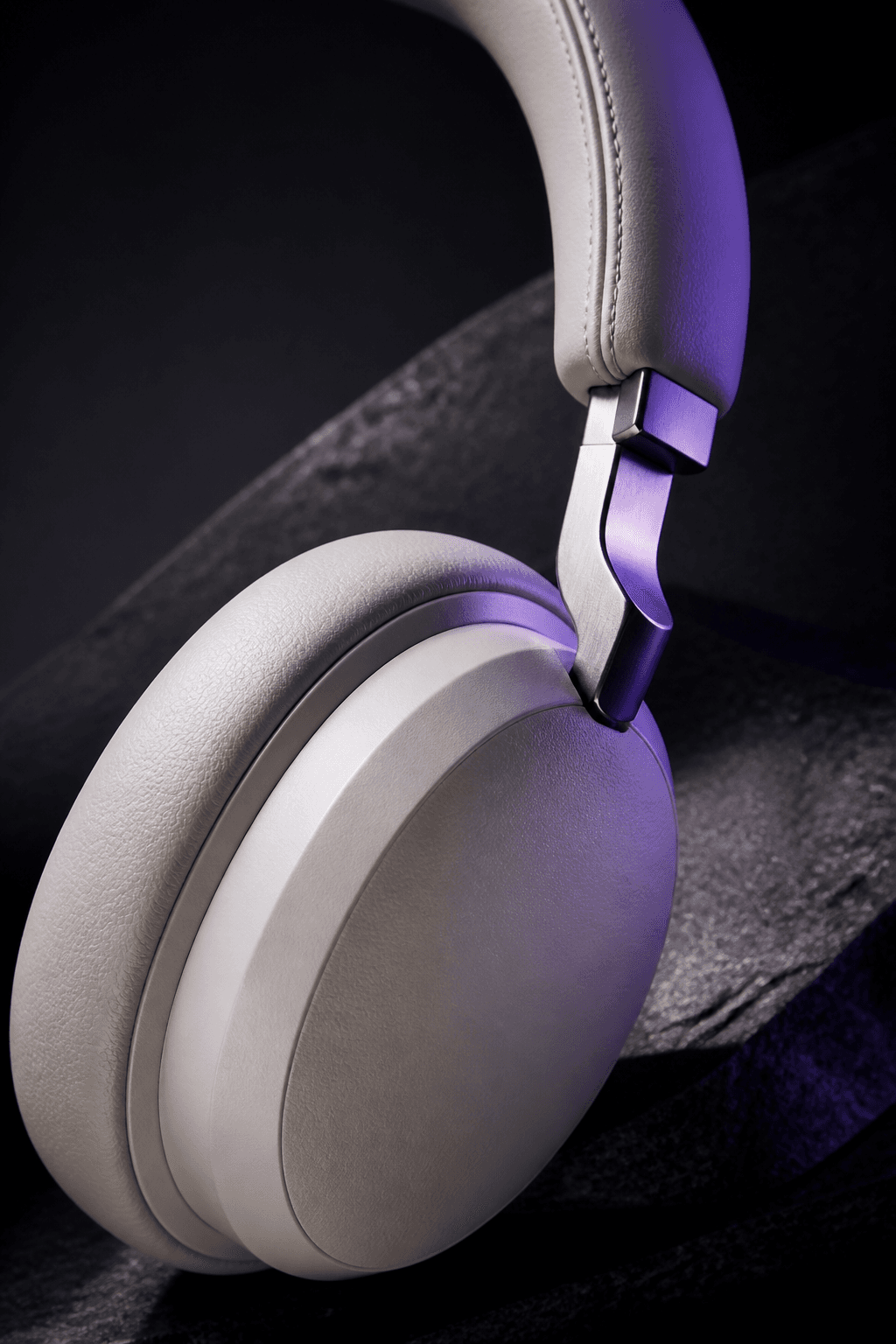 Close product photograph showing the materials and hinge detail of a pair of headphones
